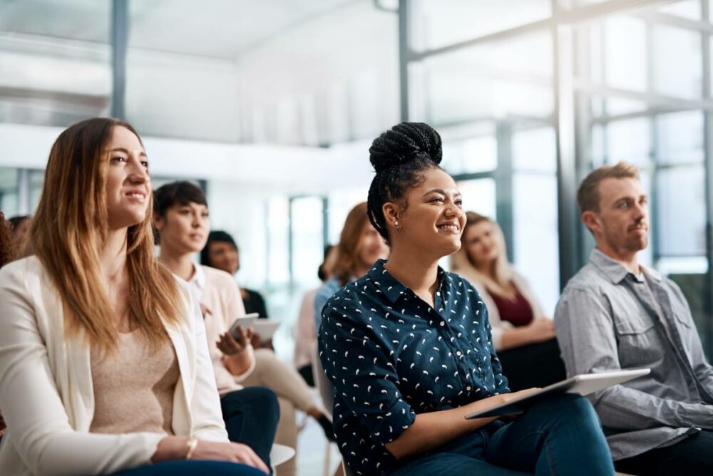 /group-of-professionals-sitting-in-seminar-style-event.jpg